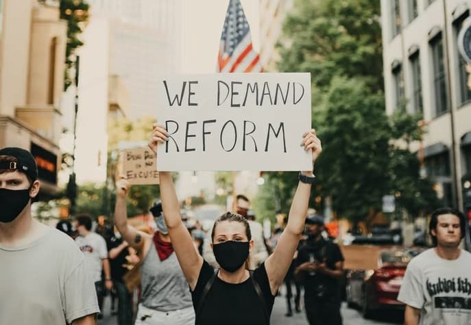 woman protesting holding sign
